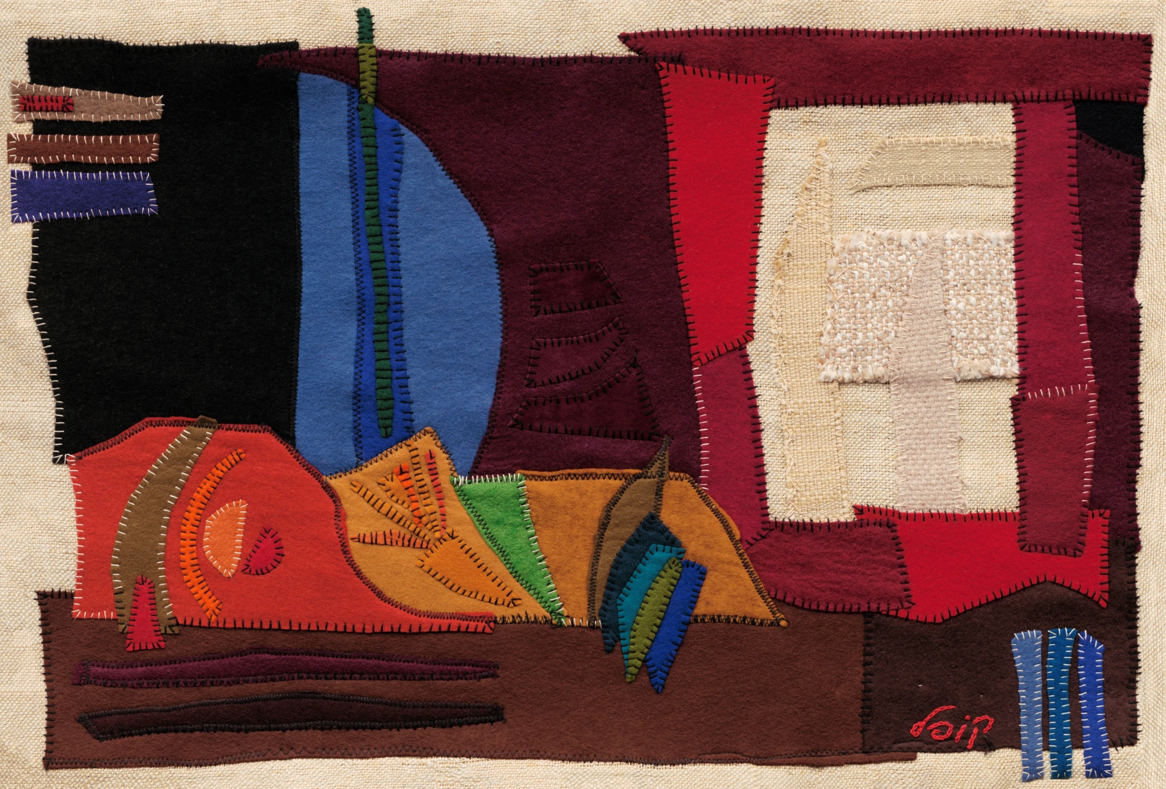 A Boat by Kopel Gurwin, an abstract hand-cut felt appliqué featuring overlapping geometric and curved shapes in burgundy, red, orange, blue, green, and brown. A pale textured rectangular panel occupies the upper right, while elongated horizontal forms suggest the structure of a boat against a natural beige fabric background.